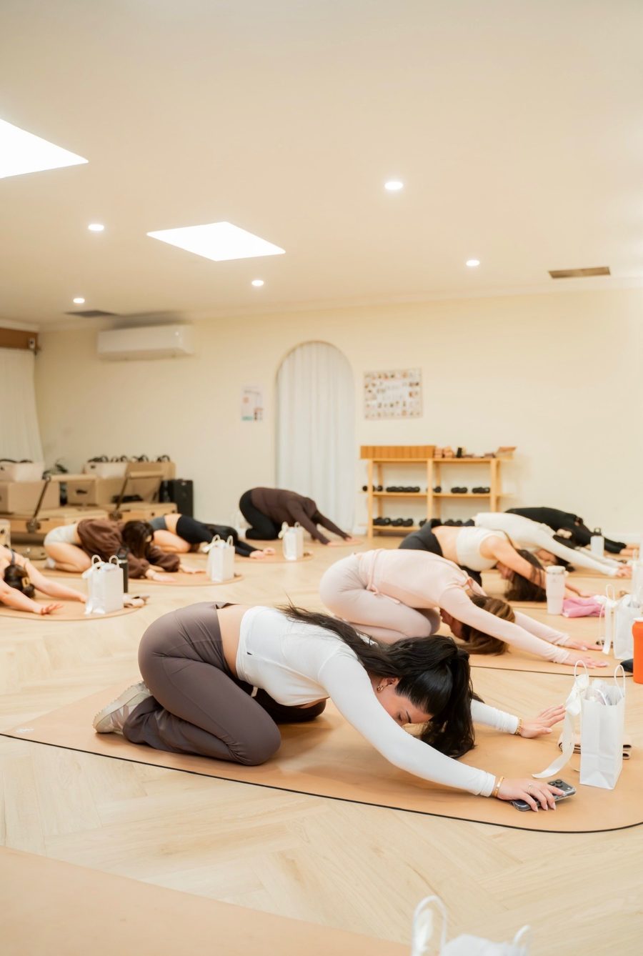 Clients in child's pose on mats during the Sunday Reset movement session